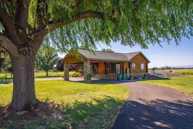 view of front of home with a front yard and a porch