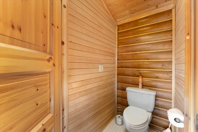 bathroom featuring toilet, tile patterned floors, and wooden ceiling