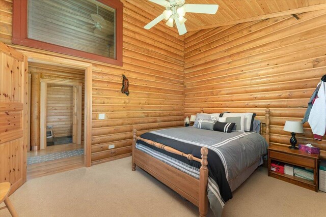 carpeted bedroom with log walls, high vaulted ceiling, wood ceiling, and ceiling fan