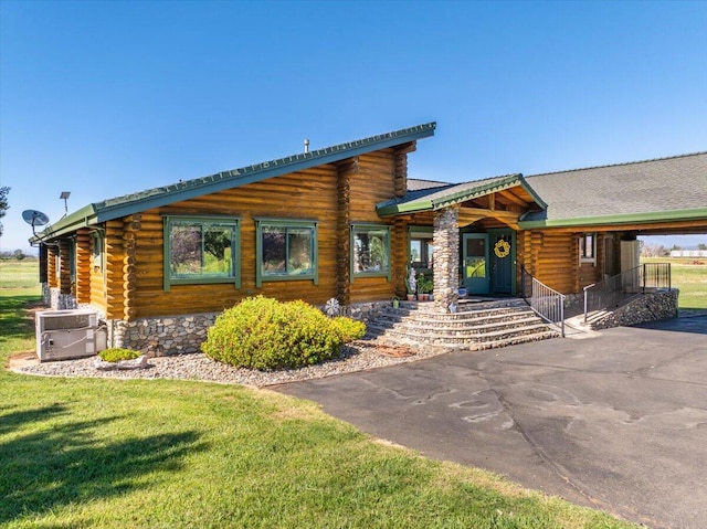 cabin featuring a front yard and central air condition unit