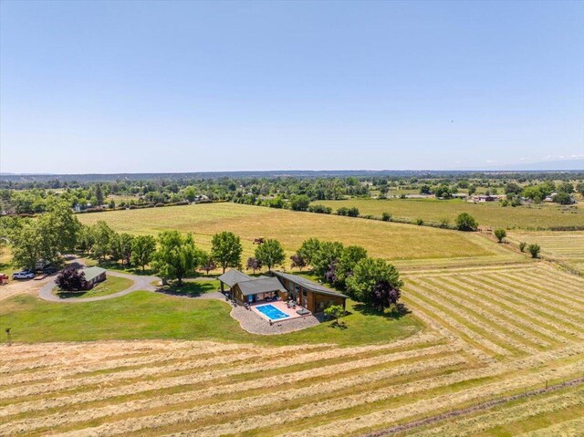 birds eye view of property with a rural view