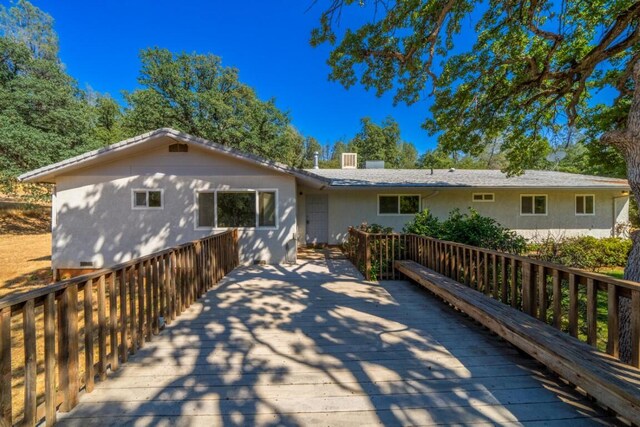 rear view of property featuring a deck