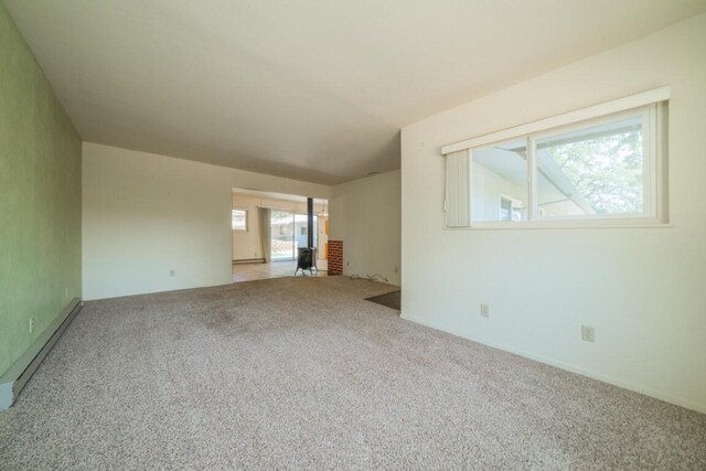 unfurnished living room with carpet flooring and a baseboard radiator