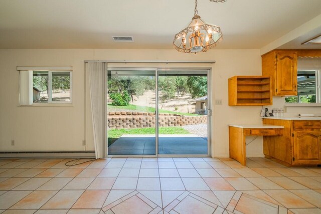 doorway to outside with light tile patterned floors, baseboard heating, and a notable chandelier