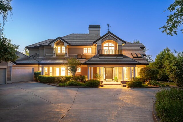 view of front of home with a balcony and a garage