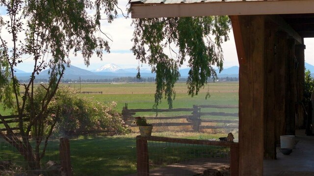 view of yard featuring a rural view and a mountain view