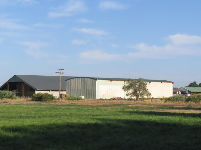 exterior space featuring an outbuilding and a lawn