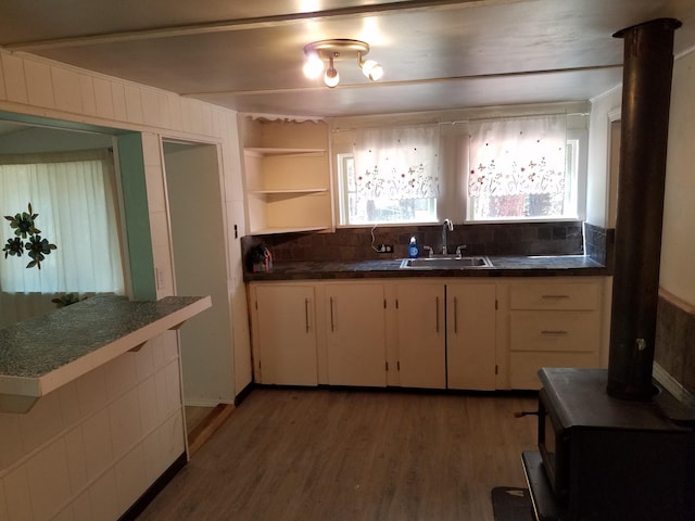 kitchen with sink, hardwood / wood-style floors, and decorative backsplash