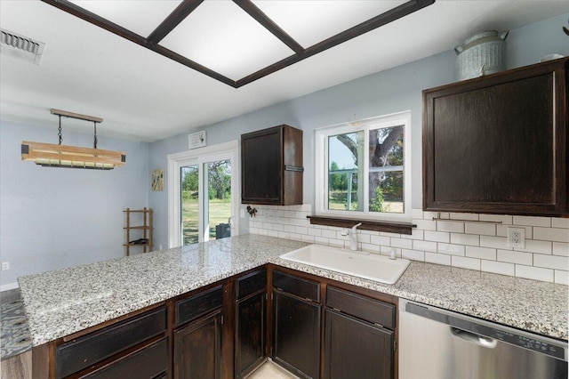 kitchen with a wealth of natural light, dishwasher, sink, and backsplash