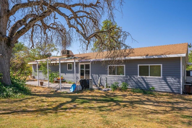 rear view of property with a yard and a patio