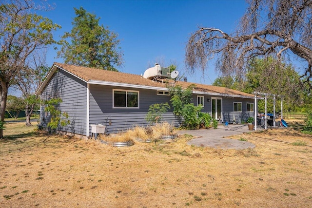 back of property featuring a lawn and a patio