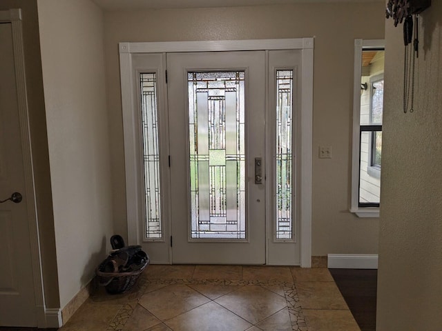 foyer with dark tile patterned floors