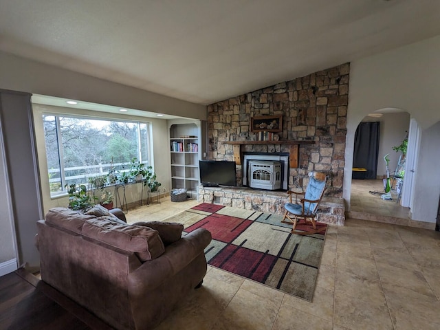 living room with lofted ceiling and built in shelves