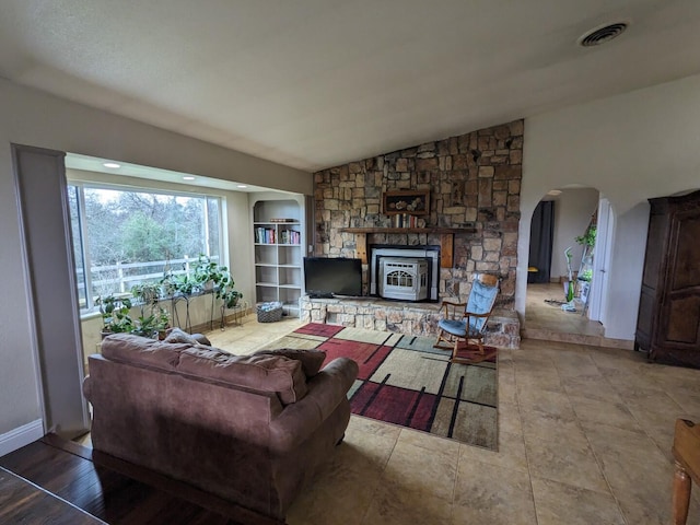 living room featuring lofted ceiling and a fireplace