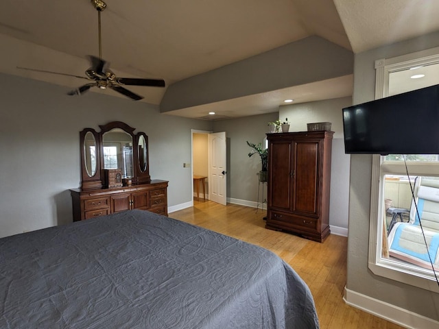 unfurnished bedroom featuring vaulted ceiling, light wood-type flooring, and ceiling fan