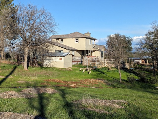 exterior space featuring a lawn and an outdoor structure