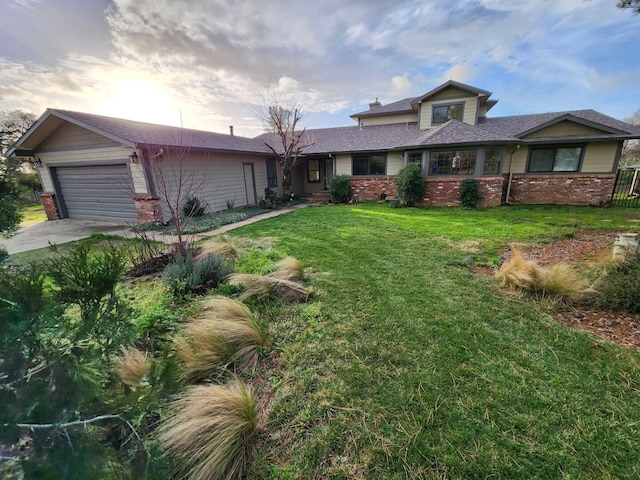 view of front of property with a lawn and a garage