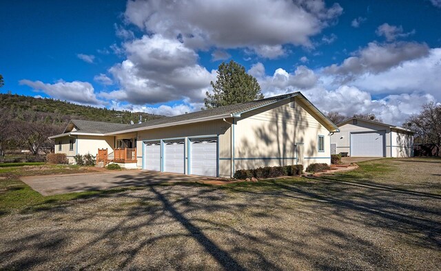 view of side of property featuring a porch and a garage