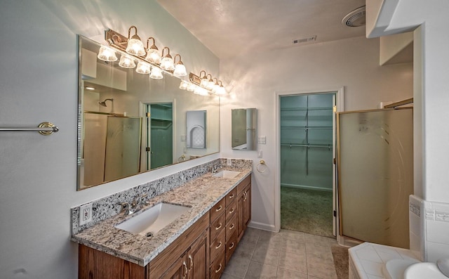 bathroom with plus walk in shower, vanity, and tile patterned floors