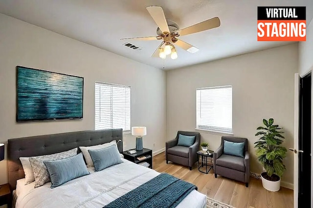 bedroom with light hardwood / wood-style floors and ceiling fan