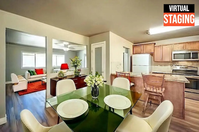 dining space featuring hardwood / wood-style floors and ceiling fan