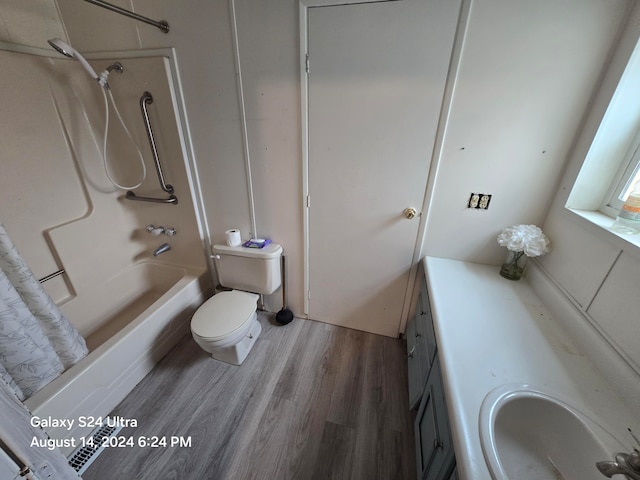 full bathroom with vanity, toilet, hardwood / wood-style flooring, and washtub / shower combination