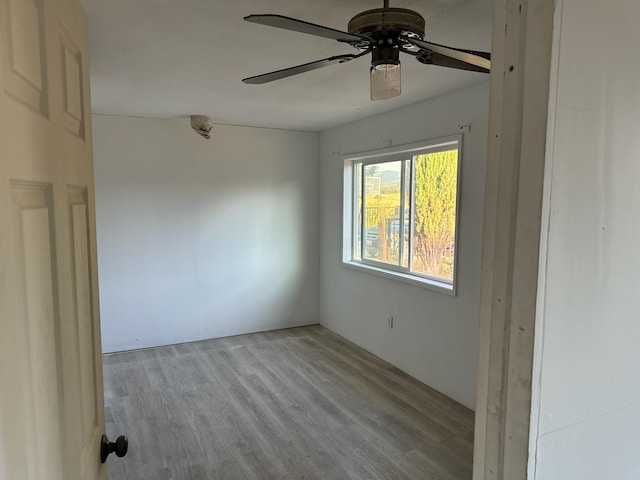 unfurnished room featuring light wood-type flooring and ceiling fan