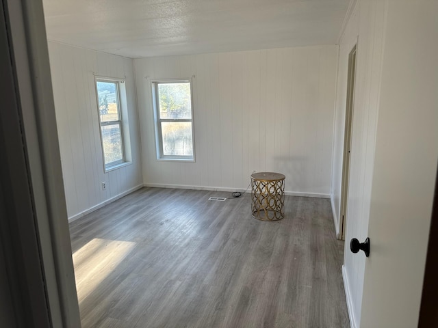 unfurnished room with wood-type flooring