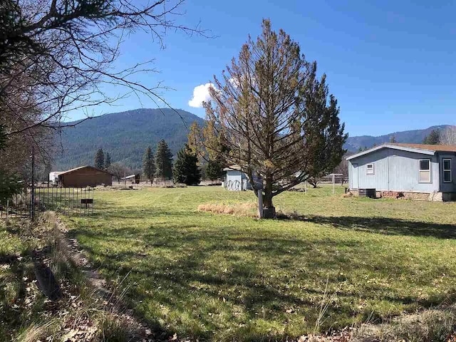 view of yard with a rural view and a mountain view