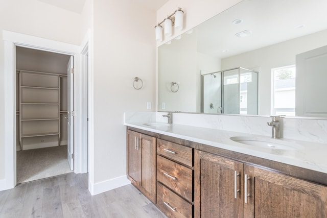 bathroom featuring vanity, hardwood / wood-style flooring, and an enclosed shower