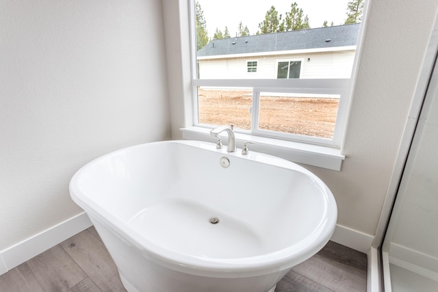 bathroom featuring a bathing tub and hardwood / wood-style flooring