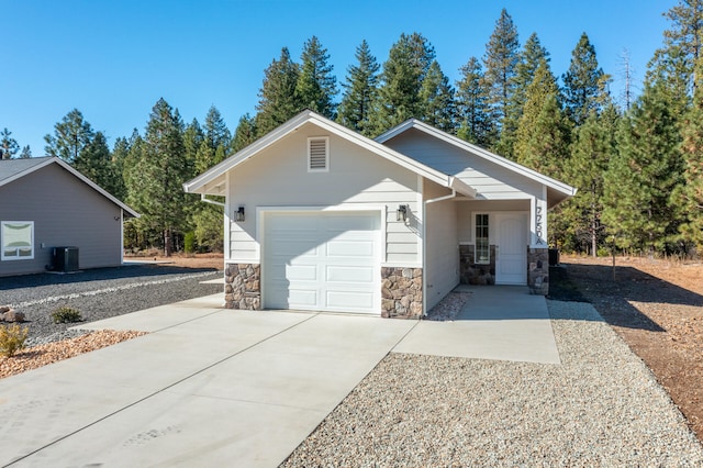 view of front facade with a garage and central AC unit