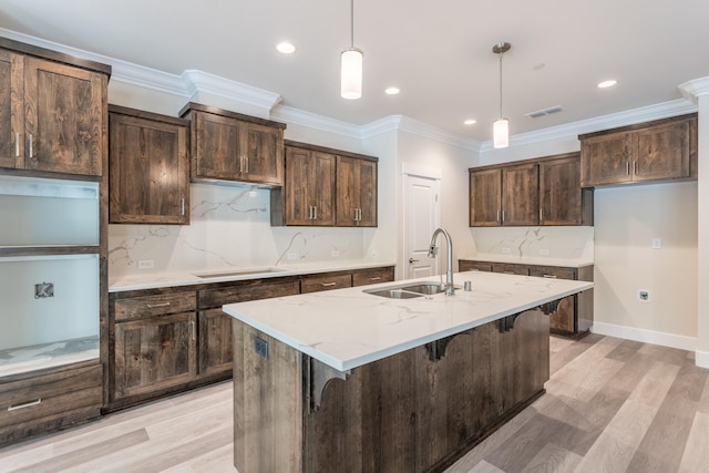 kitchen featuring sink, light wood-type flooring, and tasteful backsplash