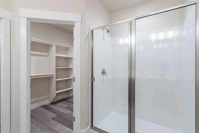 bathroom featuring hardwood / wood-style flooring and a shower with shower door