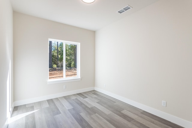 spare room with hardwood / wood-style flooring