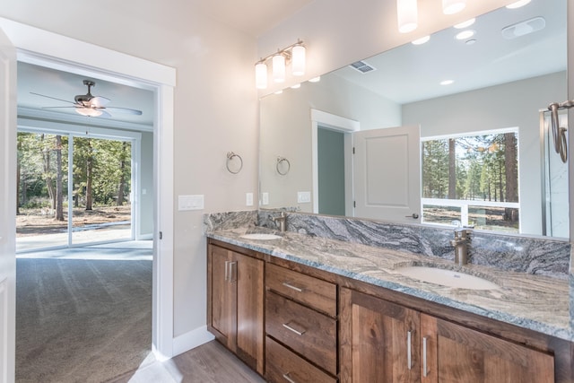 bathroom with vanity, ceiling fan, wood-type flooring, and a wealth of natural light