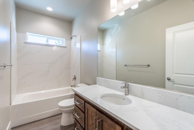 full bathroom featuring toilet, tiled shower / bath, vanity, and wood-type flooring