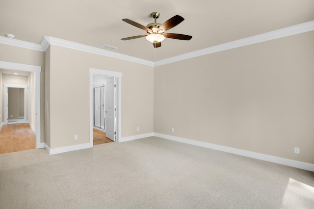 unfurnished room with ceiling fan, light colored carpet, and ornamental molding