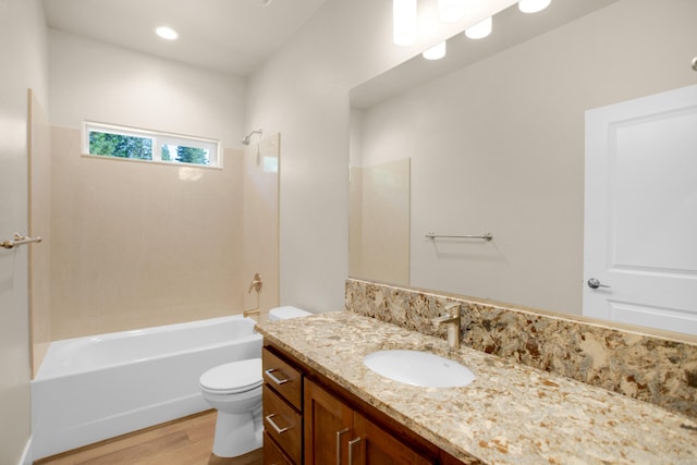 full bathroom featuring bathing tub / shower combination, hardwood / wood-style floors, vanity, and toilet