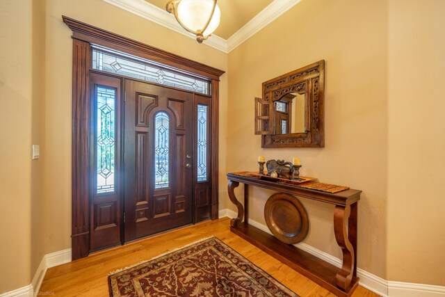 foyer featuring light hardwood / wood-style flooring and ornamental molding