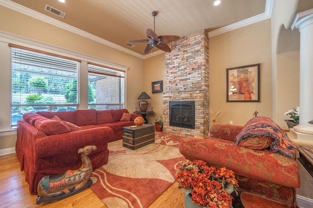 living room featuring a fireplace, ceiling fan, ornamental molding, and wood-type flooring