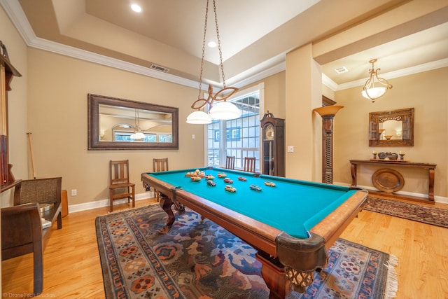 recreation room featuring billiards, light hardwood / wood-style flooring, a tray ceiling, and ornamental molding