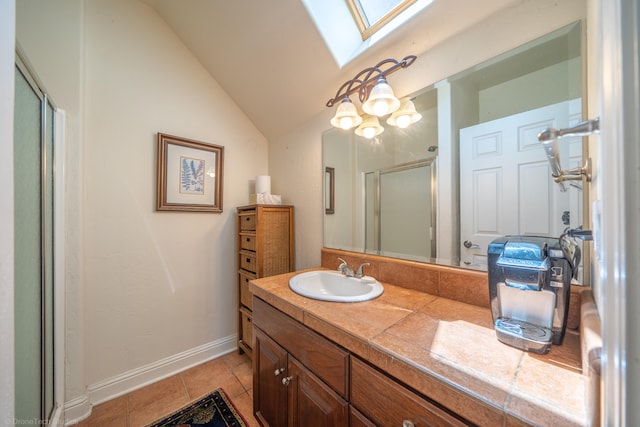 bathroom featuring tile patterned floors, an enclosed shower, lofted ceiling with skylight, and vanity