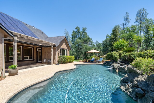 view of pool featuring a patio and pool water feature