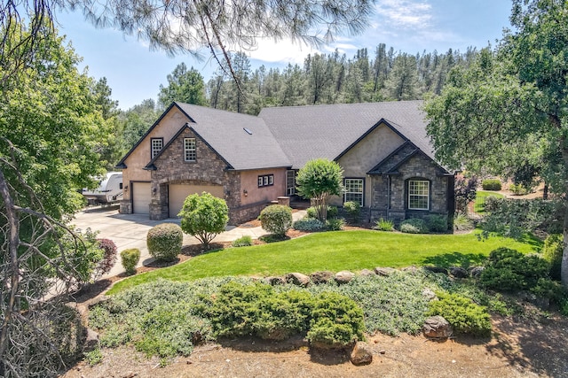 view of front of house with a front lawn and a garage