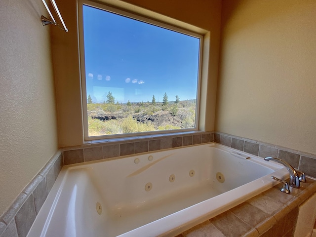 bathroom featuring a textured wall and a whirlpool tub