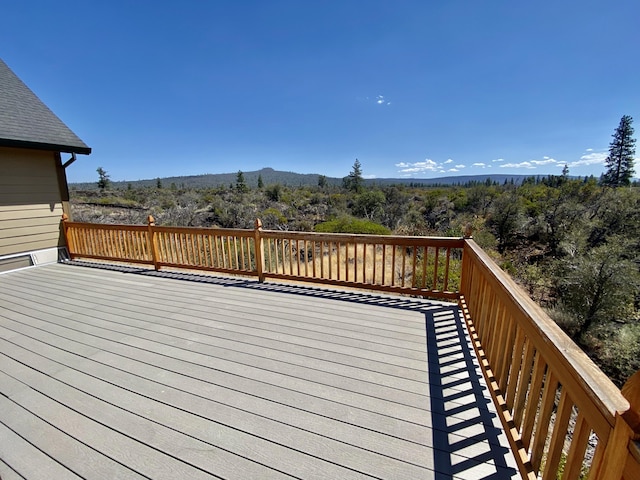 wooden deck featuring a view of trees