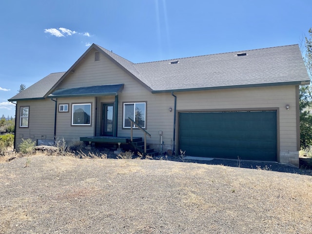 view of front of property with a garage, driveway, and a shingled roof