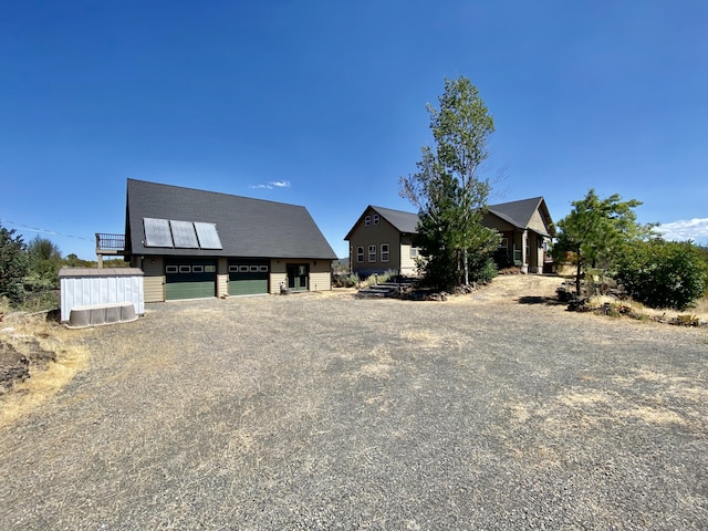 view of front of property featuring central air condition unit and a garage