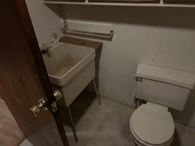 bathroom featuring toilet and tile patterned floors